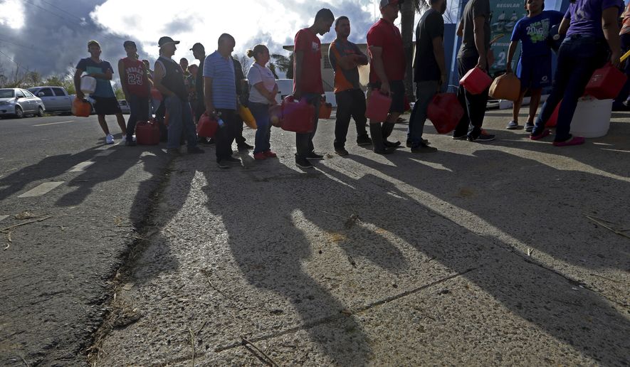 People wait in line for gas, in the aftermath of Hurricane Maria, in Aibonito, Puerto Rico, Monday, Sept. 25, 2017. The U.S. ramped up its response Monday to the humanitarian crisis in Puerto Rico while the Trump administration sought to blunt criticism that its response to Hurricane Maria has fallen short of it efforts in Texas and Florida after the recent hurricanes there. (AP Photo/Gerald Herbert)