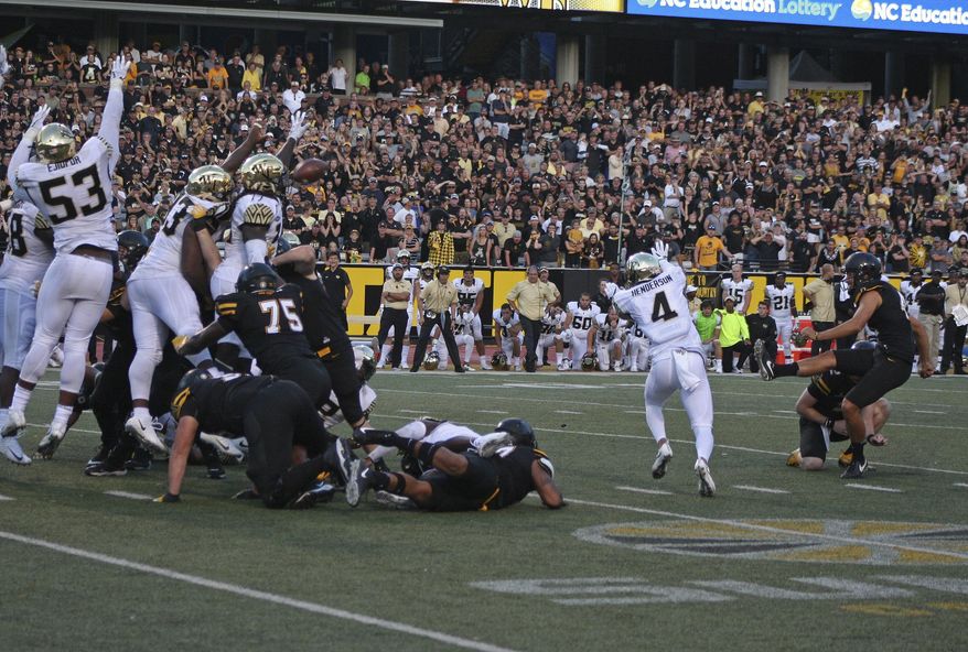 Wake Forest players attempt to block a game-winning field goal attempt by Appalachian State's Michael Rubino (41) in the final seconds of the second half of an NCAA college football game in Boone, N.C., Saturday, Sept. 23, 2017. The kick was no good. Wake Forest won 20-19. (AP Photo/Sarah Newell)
