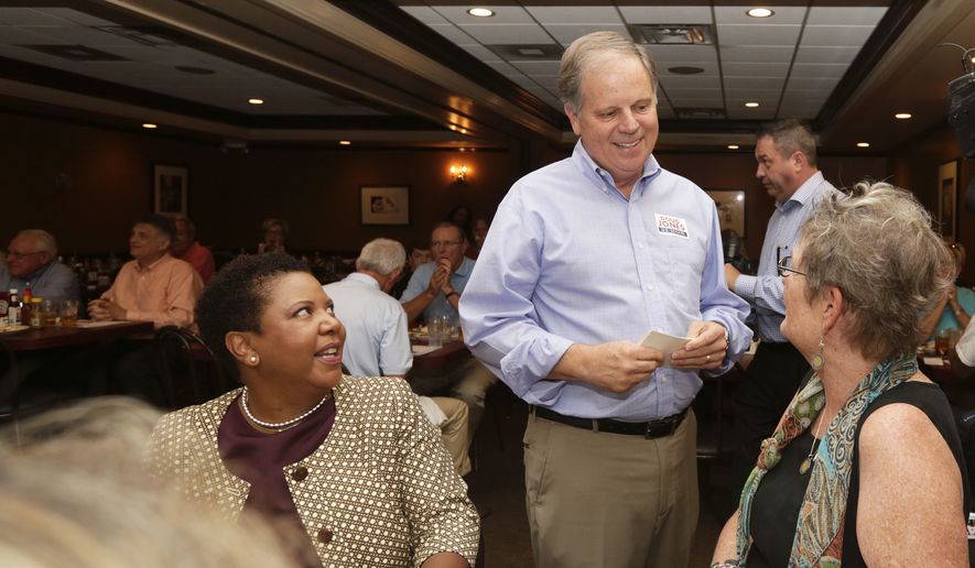 Democratic Senate nominee Doug Jones, center, talks to supporters, Jennifer L. Greer, right, and Janet Crosby, left, as he campaigns at Niki&#x27;s West restaurant, Wednesday, Sept. 27, 2017, in Birmingham, Ala. Jones will face former Alabama Chief Justice and U.S. Senate candidate Roy Moore. (AP Photo/Brynn Anderson)