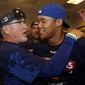 Chicago Cubs manager Joe Maddon, left, and shortstop Addison Russell celebrate after defeating the St. Louis Cardinals in a baseball game to clinch the National League Central title Wednesday, Sept. 27, 2017, in St. Louis. (AP Photo/Jeff Roberson)