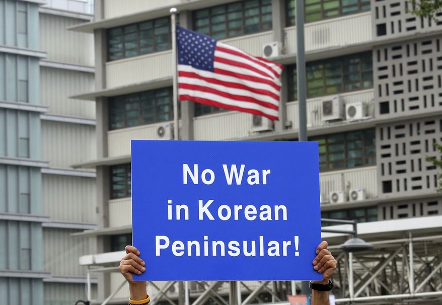 A South Korean protester holds up a card during a rally to denounce the United States' policy against North Korea in front of U.S. Embassy in Seoul, South Korea, Wednesday, Sept. 27, 2017. North Korea's top diplomat said Monday that a weekend tweet by U.S. President Donald Trump was a "declaration of war" and North Korea has the right to retaliate by shooting down U.S. bombers, even in international airspace. (AP Photo/Ahn Young-joon)