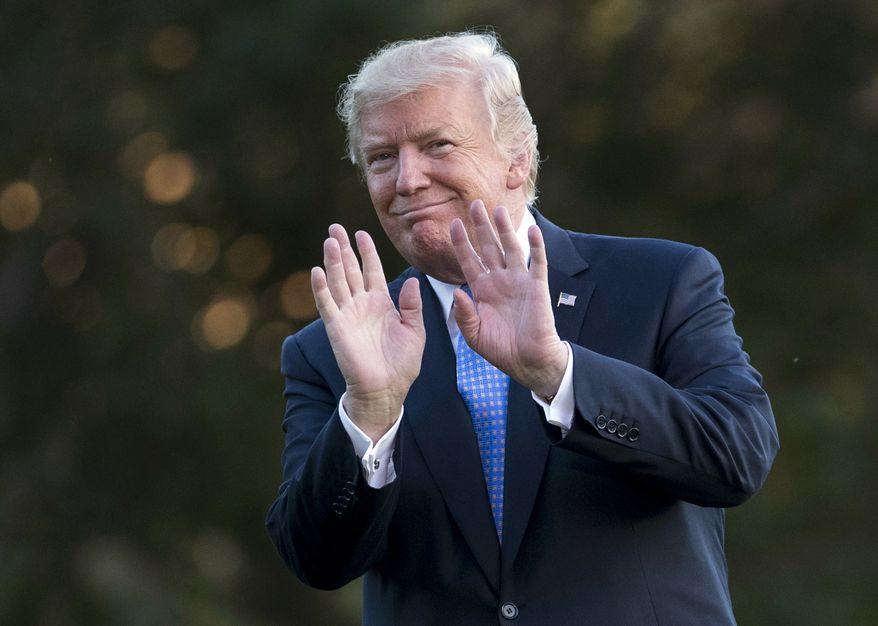 President Donald Trump gestures as he walks from Marine One across the South Lawn of the White House in Washington, Wednesday, Sept. 27, 2017, as he returns from Indianapolis. (AP Photo/Carolyn Kaster)