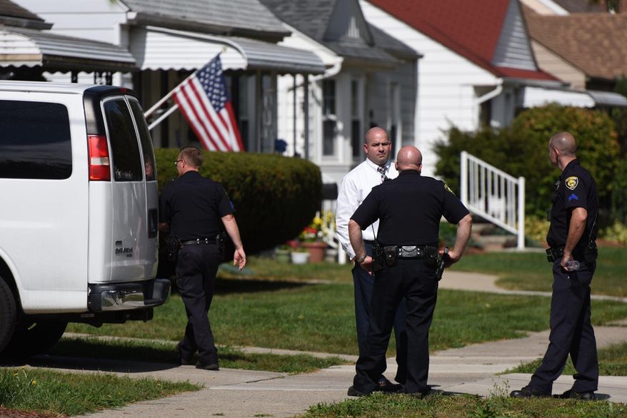 Police investigate at a home where two children were shot in Dearborn, Mich., Wednesday, Sept. 27, 2017. Police said the young children were wounded in the apparently accidental shooting at the home that was being used for childcare in suburban Detroit. (Tanya Moutzalias /The Ann Arbor News via AP)