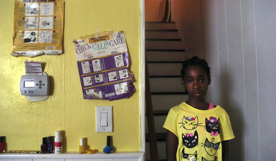 In this July 28, 2017, photo, Kathleen, 12, a disabled adopted daughter of Vivian Shine-King, poses for a portrait at her home in Philadelphia. For foster parents of disabled children, money is getting tighter. The reimbursements are seen as crucial because the high costs of caring for such children makes it less likely they'll ever be adopted. Philadelphia, Missouri and Oklahoma are among places giving payments to foster parents of disabled children a closer look. (AP Photo/Jacqueline Larma)