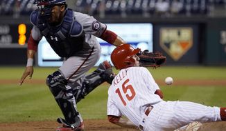 Philadelphia Phillies&#39; Ty Kelly, right, scores past Washington Nationals catcher Pedro Severino on a ball hit by Cesar Hernandez during the eighth inning of a baseball game, Wednesday, Sept. 27, 2017, in Philadelphia. Philadelphia won 7-5. Hernandez was safe at first. (AP Photo/Matt Slocum)