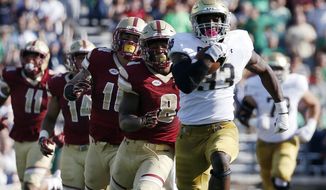 FILE - In this Saturday, Sept. 16, 2017, file photo, Notre Dame&#39;s Josh Adams (33) breaks away from Boston College defenders during the first half of an NCAA college football game in Boston.  The Irish are ranked No. 7 in the country in rushing at 293.5 yards per game and third nationally with 6.83 yards per carry. The offensive line has paved the way ever since a Sept. 9 loss to Georgia. Notre Dame hosts Miami of Ohio on Saturday. (AP Photo/Michael Dwyer)