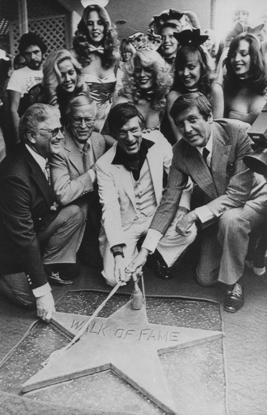 Hefner achieves star. Hugh Hefner, center, white suit, Chairman of the Board, Playboy Enterprises Inc.,is honored by the Hollywood Chamber of Commerce Wednesday in Los Angeles with the placing of his star in the Hollywood Walk of Fame. Honorary Mayor of Hollywood, Monty Hall, right, holds the rope with Hefner. (AP-Photo) 10.4.1980