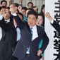Japanese Prime Minister Shinzo Abe, center, cheers with the lawmakers of the ruling Liberal Democratic Party, at the launch of the party&#39;s election headquarters in Tokyo, Thursday, Sept 28, 2017.  A surge of popularity for a freshly minted opposition party in Japan is making Prime Minister Abe’s decision to call a snap election look riskier than initially thought.  Abe dissolved the lower house of parliament Thursday, setting the stage for an Oct. 22 vote. (Takuya Inaba/Kyodo News via AP)