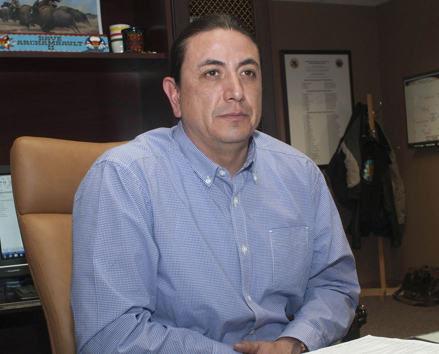 FILE - In this Feb. 6, 2014 file photo, Dave Archambault II, chairman of the Standing Rock Reservation in the Dakotas, sits at his desk in Fort Yates, N.D. The American Indian leader who spearheaded opposition to the four-state Dakota Access pipeline has been ousted as Standing Rock Sioux chairman. The unofficial vote count in Wednesday's tribal election shows that Dave Archambault got 37 percent of the vote and Mike Faith got 63 percent. Archambault conceded defeat in a statement Thursday, Sept. 28, 2017, saying he'll "continue to advocate for the issues facing our community." (AP Photo/Kevin Cederstrom, File)