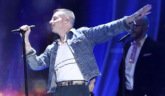 In this Sept. 23, 2017, file photo, Macklemore performs at the 2017 iHeartRadio Music Festival in Las Vegas. U.S. rapper Macklemore is wading into Australia&#39;s gay-marriage debate by vowing to sing his marriage equality anthem &amp;quot;Same Love&amp;quot; during a weekend football grand final. (John Salangsang/Invision via AP, File)