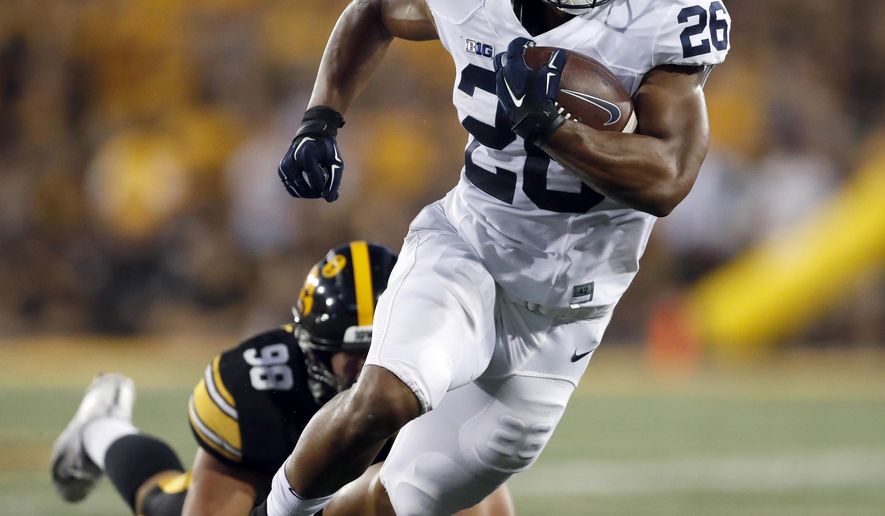 FILE - In this Sept. 23, 2017, file photo, Penn State running back Saquon Barkley carries during the first half of an NCAA college football game against Iowa in Iowa City, Iowa. Barkley leads the nation in all-purpose yards (253.3) after setting a school record with 358 yards in last week’s win at Iowa. (AP Photo/Jeff Roberson, File)