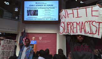 Protesters stand and hold signs and demonstrate during a speech by Education Secretary Betsy DeVos at Harvard University&#39;s Kennedy School of Government in Cambridge, Thursday. Sept. 28, 2017. She did not interrupt her speech to address the protesters, but later took some pointed questions from the audience. Asked about protections for transgender student, DeVos said she is committed to making sure all students are safe. Earlier this year, she rescinded guidance that allowed transgender students to use bathrooms that matched their gender identity. (AP Photo/Maria Danilova)