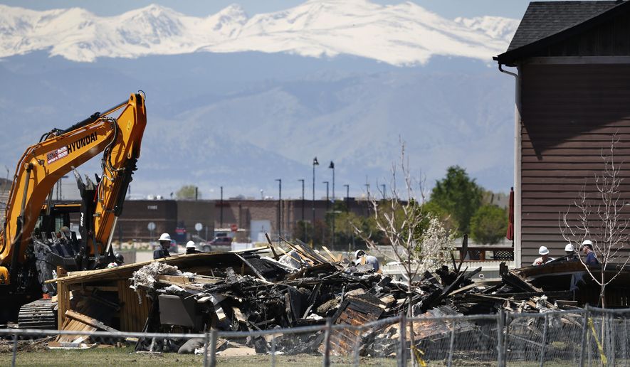 FILE - In this May 4, 2017, file photo, workers dismantle the charred remains of a house destroyed by an explosion triggered by natural gas in Firestone, Colo. Colorado regulators said that nearly 430 oil or gas pipelines near occupied buildings in Colorado failed a pressure test that the state ordered after the explosion. (AP Photo/Brennan Linsley, File)