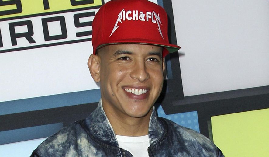 FILE - In this Oct. 8, 2015, file photo, Daddy Yankee poses backstage at the Latin American Music Awards in Los Angeles. On Sept. 28, 2017, Daddy Yankee pledged $1 million to Hurricane Maria relief in his native Puerto Rico. (Photo by Paul A. Hebert/Invision/AP, File)