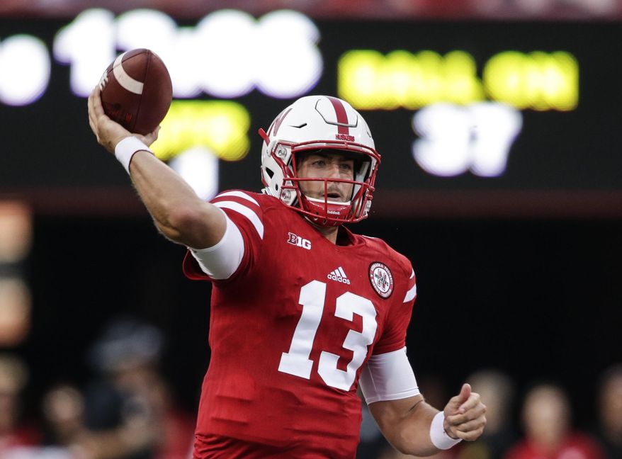 FILE - In this Sept. 2, 2017, file photo, Nebraska quarterback Tanner Lee (13) throws during the first half of an NCAA college football game against Arkansas State in Lincoln, Neb. All eyes will be on the quarterbacks when Nebraska and Illinois meet on Friday night. (AP Photo/Nati Harnik, File)