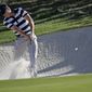 Jordan Spieth hits from a sand trap on the 11th hole during the Presidents Cup foursomes golf matches at Liberty National Golf Club in Jersey City, N.J., Thursday, Sept. 28, 2017. (AP Photo/Julio Cortez)