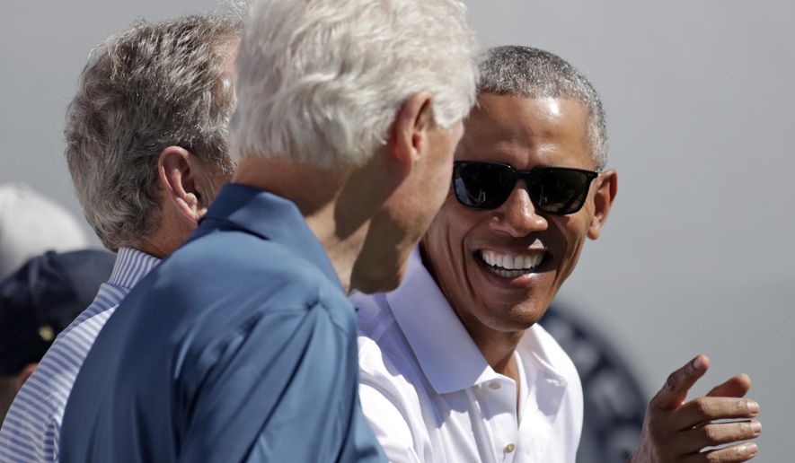 Former President Barack Obama, right, jokes with formers Presidents Bill Clinton, center and George Bush, left, before the first round of the Presidents Cup at Liberty National Golf Club in Jersey City, N.J., Thursday, Sept. 28, 2017. (AP Photo/Julio Cortez)