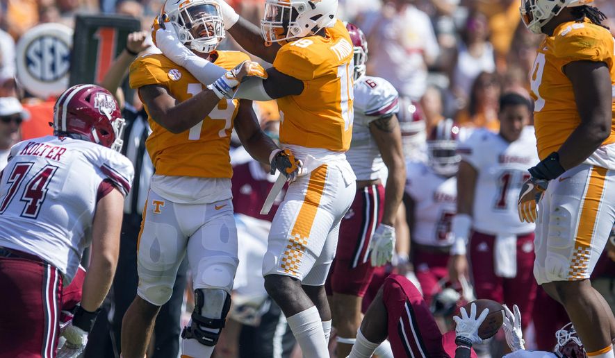 FILE - In this Saturday, Sept. 23, 2017, file photo, Tennessee linebacker Quart'e Sapp (14) and defensive lineman Darrell Taylor (19) celebrate after making a play against Massachusetts during an NCAA college football game in Knoxville, Tenn. Tennessee is coming off a seven-sack performance against Massachusetts as the Volunteers prepare to face No. 7 Georgia and freshman quarterback Jake Fromm. (Clavin Mattheis/Knoxville News Sentinel via AP)