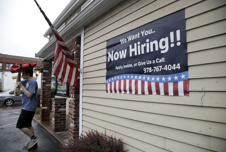 FILE - In this July 24, 2017, file photo, a sign advertising employment hangs outside a restaurant in Middleton, Mass. The number of Americans applying for unemployment benefits rose by 12,000 the week of Sept. 18, to 272,000 as Florida continued to absorb the economic impact of Hurricane Irma. (AP Photo/Elise Amendola, File)