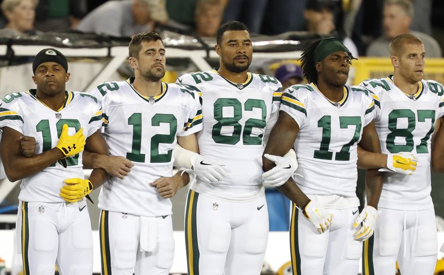 Green Bay Packers link arms during the national anthem before an NFL football game against the Chicago Bears Thursday, Sept. 28, 2017, in Green Bay, Wis. (AP Photo/Matt Ludtke)