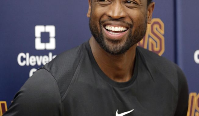 Cleveland Cavaliers&#x27; Dwyane Wade smiles as he answers questions during a news conference at the NBA basketball team&#x27;s training facility, Friday, Sept. 29, 2017, in Independence, Ohio. Wade once convinced LeBron James that Miami was the place to be. Seven years later, James lured Wade to Ohio for the chance to win another NBA title, together. (AP Photo/Tony Dejak)