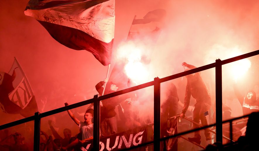 Rijeka fans light flares during the Europa League group D soccer match between AC Milan and Rijeka, at the Milan San Siro Stadium, Italy, Thursday, Sept. 28, 2017. (AP Photo/Luca Bruno)