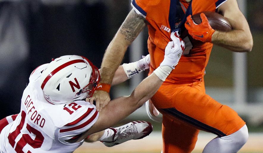 Illinois quarterback Chayce Crouch (7) tries to get away from Nebraska linebacker Luke Gifford (12) during the first half of an NCAA college football game Friday, Sept. 29, 2017, in Champaign, Ill. (AP Photo/Stephen Haas)