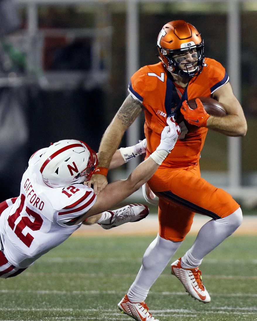 Illinois quarterback Chayce Crouch (7) tries to get away from Nebraska linebacker Luke Gifford (12) during the first half of an NCAA college football game Friday, Sept. 29, 2017, in Champaign, Ill. (AP Photo/Stephen Haas)