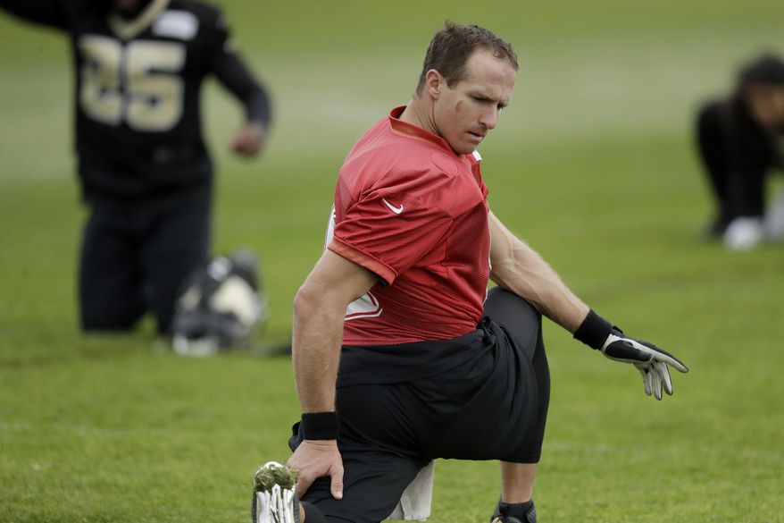 New Orleans Saints quarterback Drew Brees takes part in a stretching session of an NFL training session at the London Irish rugby team training ground in the Sunbury-on-Thames suburb of south west London, Friday, Sept. 29, 2017. The New Orleans Saints are preparing for an NFL regular season game against the Miami Dolphins at London's Wembley stadium on Sunday. (AP Photo/Matt Dunham)
