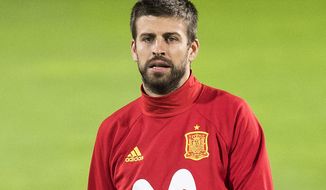 FILE  - In this Monday, Sept 4, 2017 file photo, Spain&#39;s Gerard Pique takes part in a training session a day prior to the World Cup Group G qualifying soccer match between Liechtenstein and Spain at the Rheinpark stadium in Vaduz, Liechtenstein. Spain coach Julen Lopetegui has defended Gerard Pique from critics who question his loyalty to the national team because of his support for a disputed referendum on Catalan independence. (Gian Ehrenzeller/Keystone via AP, FIle)