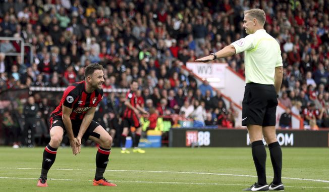 AFC Bournemouth&#x27;s Marc Pugh, left, appeals to referee Graham Scott during the English Premier League soccer match between Leicester City and AFC Bournemouth at the Vitality Stadium, Bournemouth, England, Saturday Sept. 30, 2017. (Simon Cooper/PA via AP)