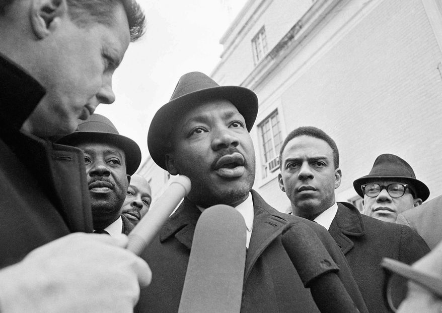 In this Feb. 5, 1965, file photo, Dr. Martin Luther King Jr. is interviewed by newsmen as he left jail in Selma, Ala. (AP Photo/HC, File)