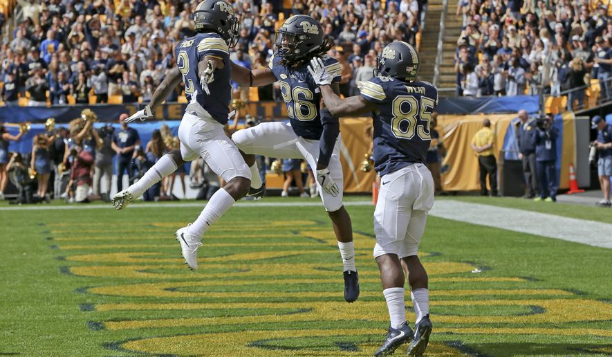 Pittsburgh running back Chawntez Moss (26) celebrates with teammates Jester Weah (85) and Maurice Ffrench (2) after scoring a touchdown against Rice in the first quarter of an NCAA college football game, Saturday, Sept. 30, 2017, in Pittsburgh. (AP Photo/Keith Srakocic)
