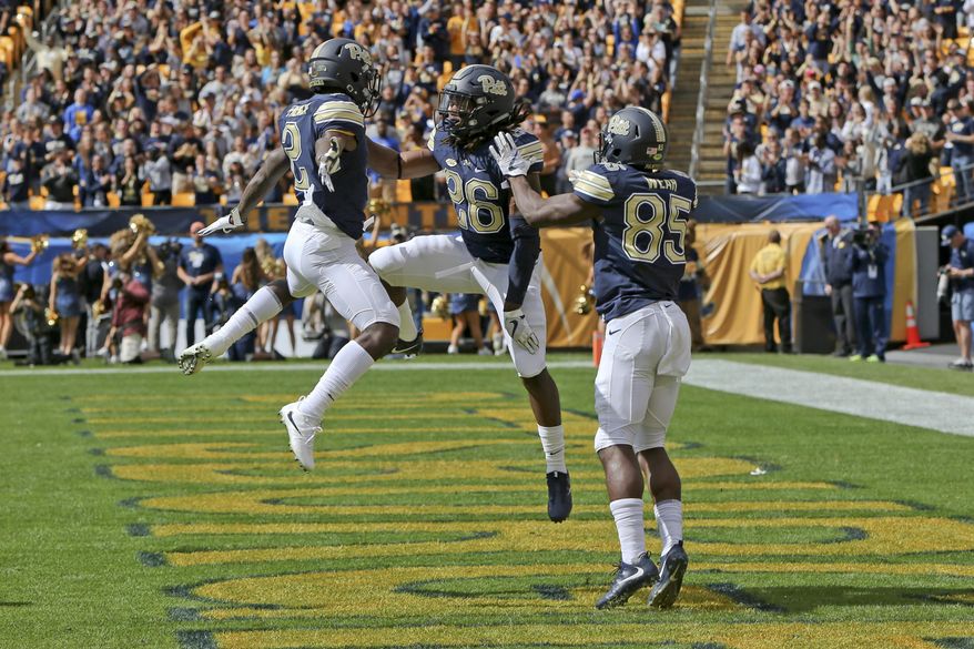 Pittsburgh running back Chawntez Moss (26) celebrates with teammates Jester Weah (85) and Maurice Ffrench (2) after scoring a touchdown against Rice in the first quarter of an NCAA college football game, Saturday, Sept. 30, 2017, in Pittsburgh. (AP Photo/Keith Srakocic)