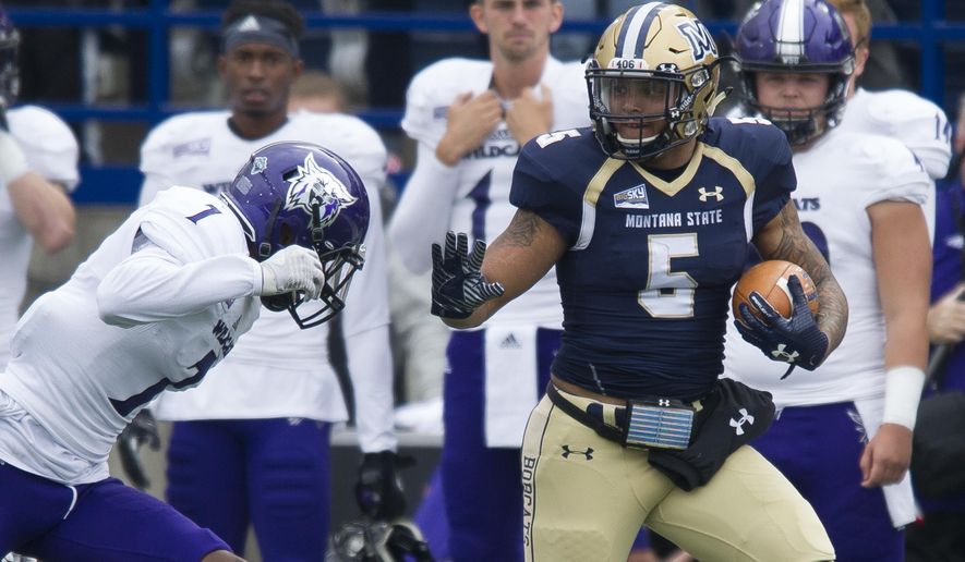 In this photo provided by Montana State University, Montana State running back Edward Vander (5) is defended by Weber State cornerback Taron Johnson (1) during the first half of an NCAA college football game Saturday, Sept. 30, 2017, in Bozeman, Mont. (Kelly Gorham/Montana State University via AP)