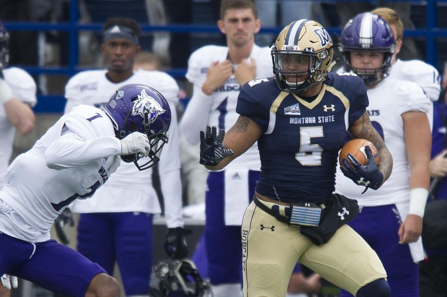 In this photo provided by Montana State University, Montana State running back Edward Vander (5) is defended by Weber State cornerback Taron Johnson (1) during the first half of an NCAA college football game Saturday, Sept. 30, 2017, in Bozeman, Mont. (Kelly Gorham/Montana State University via AP)