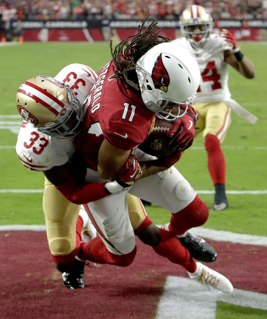 Arizona Cardinals wide receiver Larry Fitzgerald (11) pulls in the game winning touchdown as San Francisco 49ers cornerback Rashard Robinson (33) defends during overtime of an NFL football game, Sunday, Oct. 1, 2017, in Glendale, Ariz. The Cardinals won 18-15. (AP Photo/Rick Scuteri)