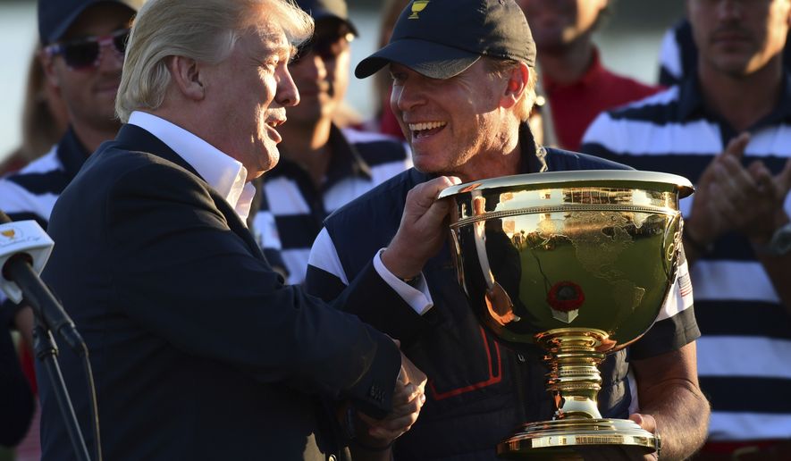 President Donald Trump participates in presenting the Presidents Cup to the United States team at the Jersey City Golf Club in Jersey City, N.J., Sunday, Oct. 1, 2017, after the United States team defeated the International team in the Presidents Cup for the 7th straight time. (AP Photo/Susan Walsh)