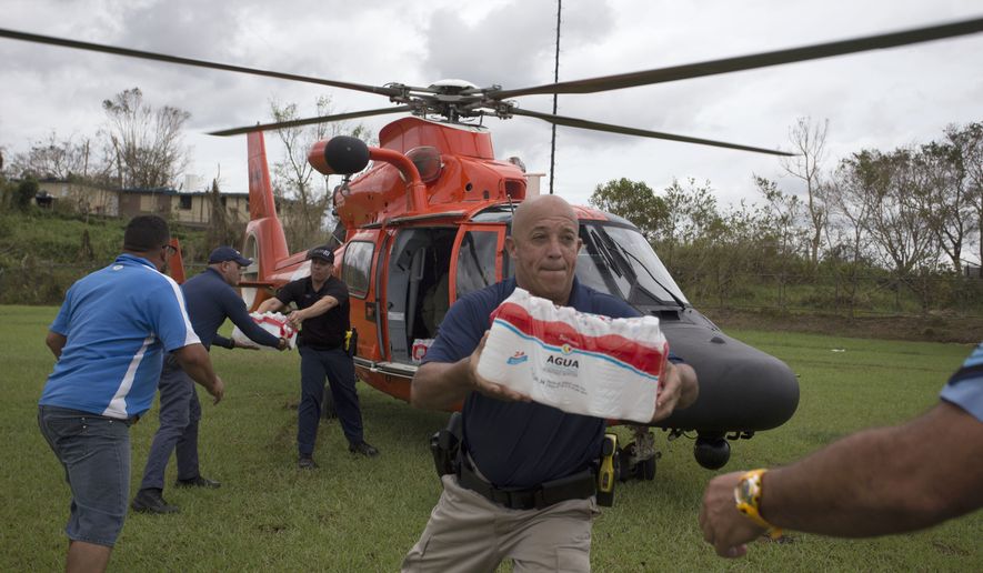 A cost guard helicopter arrives to deliver emergency supplies after the passing of of Hurricane Maria, in Utuado, Puerto Rico, Saturday, Sept. 30 2017. San Juan Mayor Carmen Yulin Cruz on Friday accused the Trump administration of &quot;killing us with the inefficiency&quot; after the storm. She begged the president, who is set to visit Puerto Rico on Tuesday, to &quot;make sure somebody is in charge that is up to the task of saving lives,&quot; and appealed for help &quot;to save us from dying.&quot; (Thais Llorca/Pool Photo via AP)