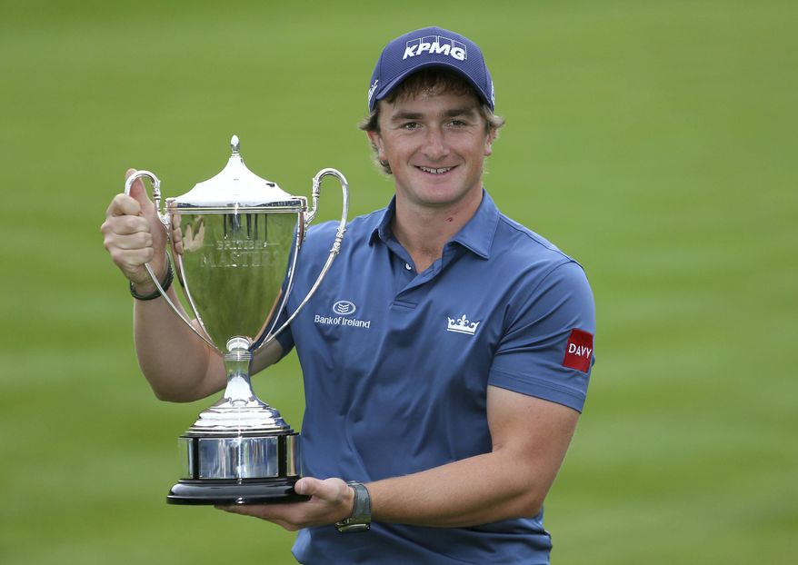 Ireland's Paul Dunne celebrates with the trophy during day four of the British Masters at Close House Golf Club, Newcastle, England, Sunday, Oct. 1, 2017. (Richard Sellers/PA via AP)