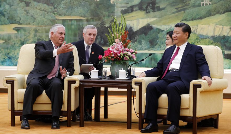 U.S. Secretary of State Rex Tillerson, left, chats with China&#x27;s President Xi Jinping during a meeting at the Great Hall of the People in Beijing, Saturday, Sept. 30, 2017. (AP Photo/Andy Wong, Pool)