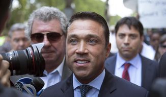 FILE- In this July 17, 2015 file photo, former U.S. Rep. Michael Grimm, center, leaves following his sentencing at federal court in the Brooklyn borough of New York. Grimm, who went to prison for tax fraud and once threatened to throw a TV reporter off a balcony, is set to announce Sunday, Oct. 1, 2017, that he will try to reclaim his old seat in Congress. (AP Photo/Kevin Hagen, File)