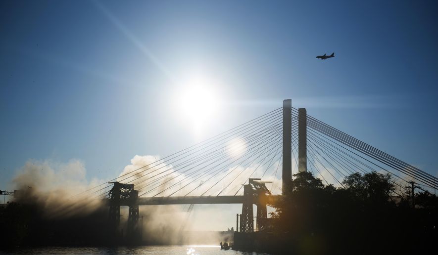 The old Kosciuszko Bridge is imploded on Sunday, Oct. 1, 2017 in New York. Over 900 explosives brought down the 20 remaining steel truss spans. The eastbound span of the new Kosciuszko Bridge opened in April. The second span is scheduled to be finished by 2020. (AP Photo/Michael Noble Jr.)