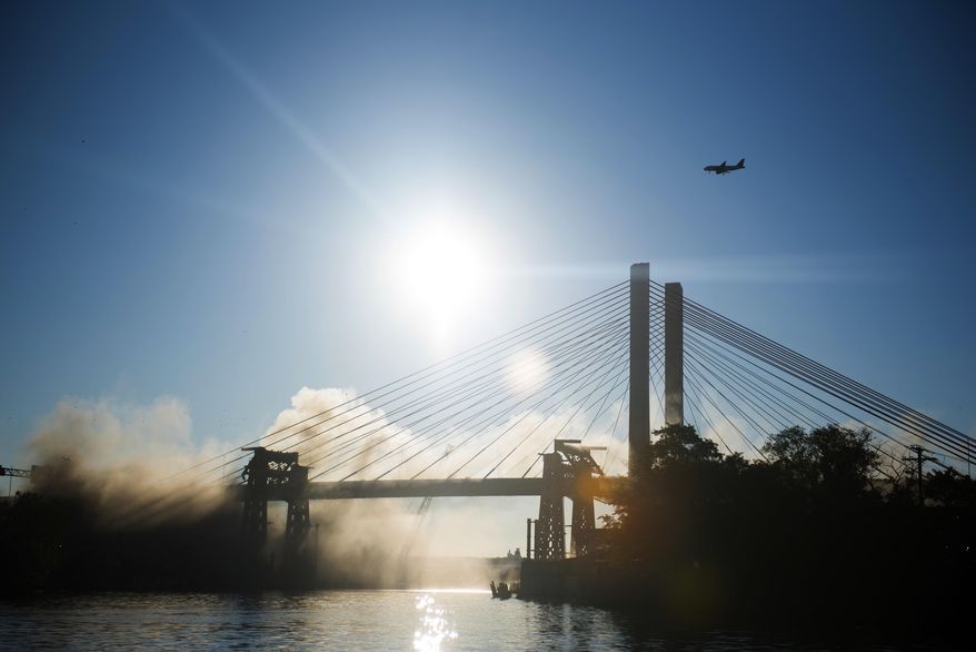 The old Kosciuszko Bridge is imploded on Sunday, Oct. 1, 2017 in New York. Over 900 explosives brought down the 20 remaining steel truss spans. The eastbound span of the new Kosciuszko Bridge opened in April. The second span is scheduled to be finished by 2020. (AP Photo/Michael Noble Jr.)