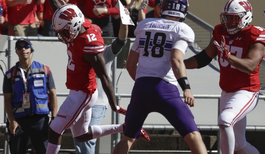 Wisconsin's Natrell Jamerson scores in front of Northwestern's Clayton Thorson (18) after intercepting a pass during the second half of an NCAA college football game Saturday, Sept. 30, 2017, in Madison, Wis. Wisconsin won 33-24. (AP Photo/Morry Gash)