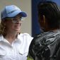 Mayor Carmen Yulin Cruz speaks with a man as she arrives at San Francisco hospital in the Rio Piedras area of San Juan, Puerto Rico, Saturday, Sept. 30, 2017, as about 35 patients are evacuated after the failure of an electrical plant. (AP Photo/Carlos Giusti)
