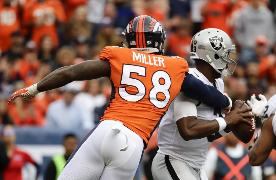 Denver Broncos outside linebacker Von Miller, left, sacks Oakland Raiders quarterback EJ Manuel during the second half of an NFL football game Sunday, Oct. 1, 2017, in Denver. (AP Photo/Jack Dempsey)