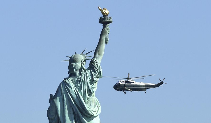 Marine One, with President Donald Trump on board, flies past the Statue of Liberty, as it heads to the Liberty Park landing zone in Jersey City, N.J., Sunday, Oct. 1, 2017. Trump is heading to attend the Presidents Cup golf tournament at the Jersey City Golf Course. (AP Photo/Susan Walsh)