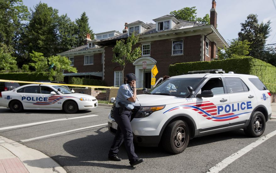 Washington police secure the vicinity around the fire-damaged multimillion-dollar home in northwest Washington, Wednesday, May 20, 2015, where four people were found dead May 14. Washington Police Chief Cathy Lanier earlier identified two of the victims found dead as 46-year-old Savvas Savopoulos and his 47-year-old wife, Amy Savopoulos. Police believe the other two victims are the couple's 10-year-old son and a housekeeper. Police say the deaths are being investigated as a homicide. . (AP Photo/Manuel Balce Ceneta)