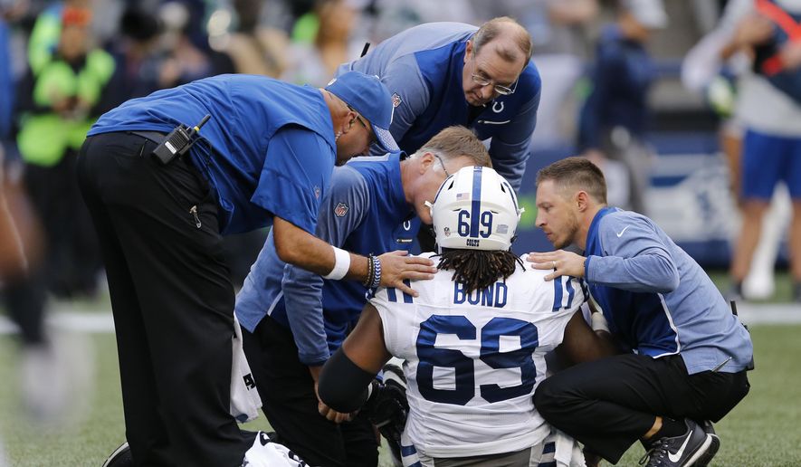 Indianapolis Colts center Deyshawn Bond (69) is tended to after he went down with an injury in the first half of an NFL football game against the Seattle Seahawks, Sunday, Oct. 1, 2017, in Seattle. (AP Photo/Stephen Brashear)